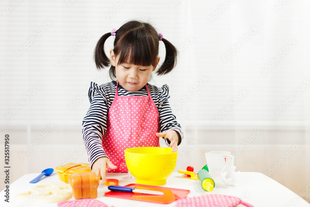 toddler girl pretend play food preparing role at home against white background toddler girl pretend play food preparing role at home against white background