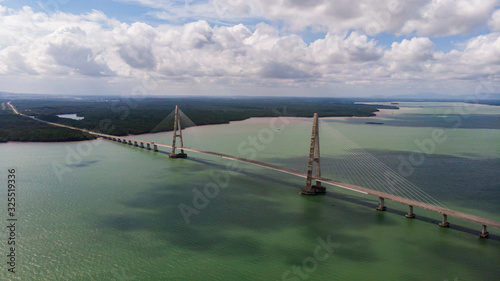 The Johor Bridge at the south of Malaysia from the sky. Cars passing by on the Bridge.  Pass the ocean bay near the city of Singapore. The Highway ends at Desaru Coast, holiday resort for Singaporeans