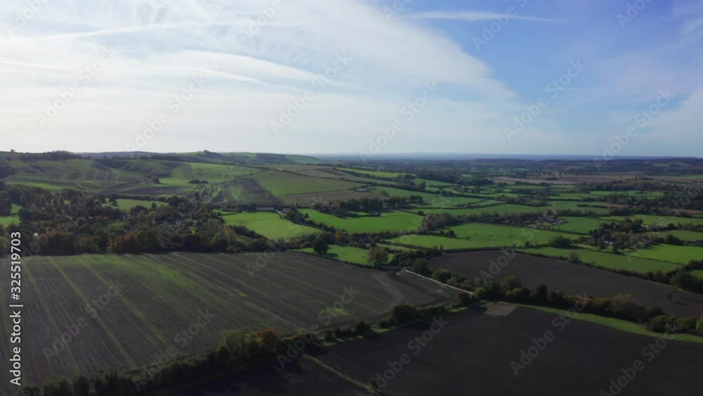Aerial view of green and ploughed fields, shot on a bright autumn day with blue skies. Aerial view of green and ploughed fields, shot on a bright autumn day with blue skies.