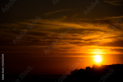 Contrast background with a bright setting sun © savelov
