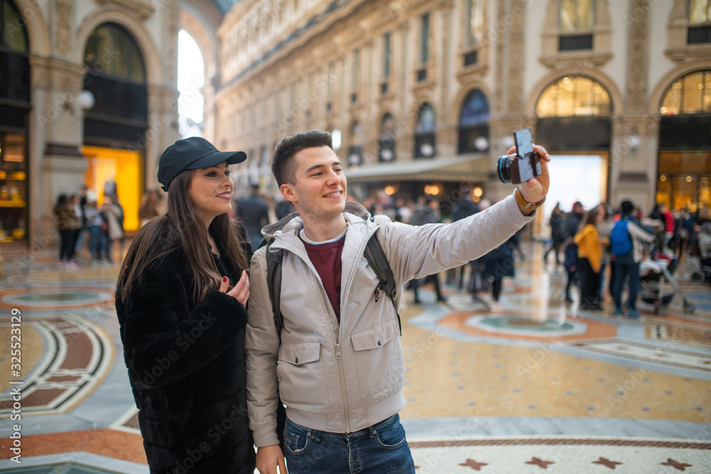Couple of turists taking a selfie in a city