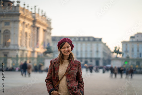 beautiful girl brunette tourist visiting Torino (Turin), Italy. Traveling in europe capitals and visiting the city center Castle square