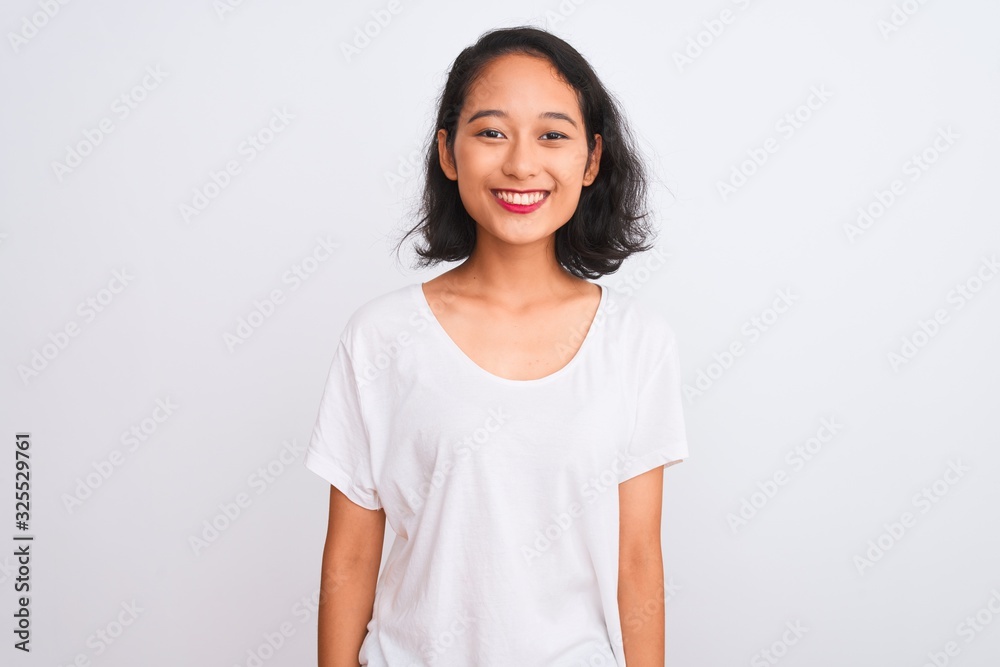 Young chinese woman wearing casual t-shirt standing over isolated white background with a happy and cool smile on face. Lucky person. Young chinese woman wearing casual t-shirt standing over isolated white background with a happy and cool smile on face. Lucky person.