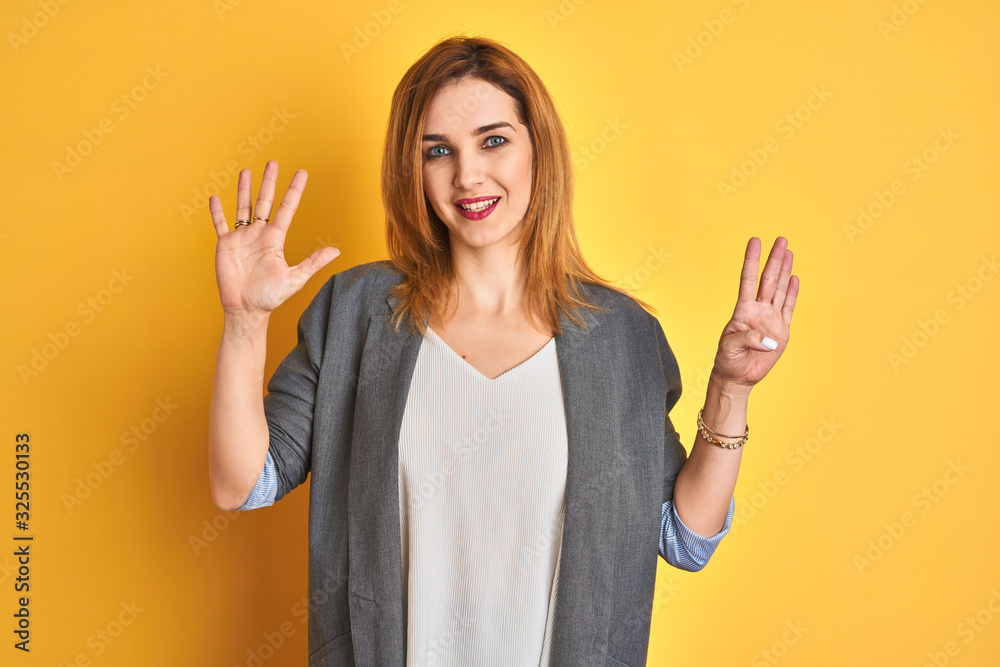 Redhead caucasian business woman over yellow isolated background showing and pointing up with fingers number nine while smiling confident and happy. Redhead caucasian business woman over yellow isolated background showing and pointing up with fingers number nine while smiling confident and happy.