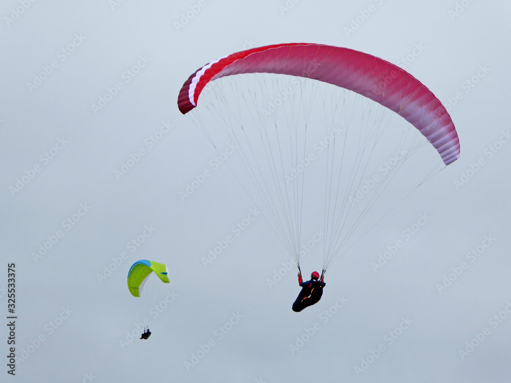 Paraglider flying wing in a blue sky Paraglider flying wing in a blue sky