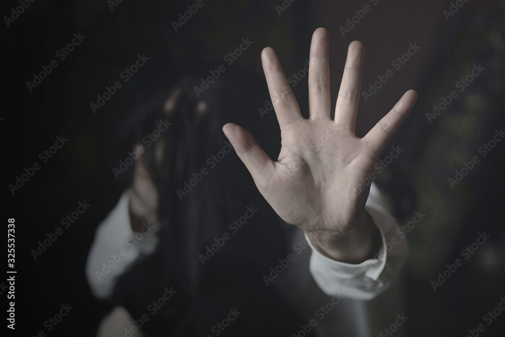 Woman covering her face in fear of domestic violence against. international women's day Woman covering her face in fear of domestic violence against. international women's day