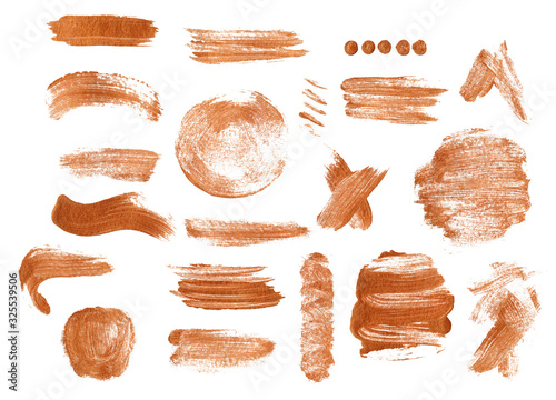 Gouache strokes of gold paint on a white paper top view. Brush strokes on a white background isolate. Dry strokes of various forms of paint.