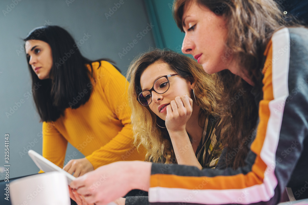 Close Up Shot Of Casual Young Business Team At Work In Creative Office. Brainstorming and sharing new ideas with colleagues Close Up Shot Of Casual Young Business Team At Work In Creative Office. Brainstorming and sharing new ideas with colleagues