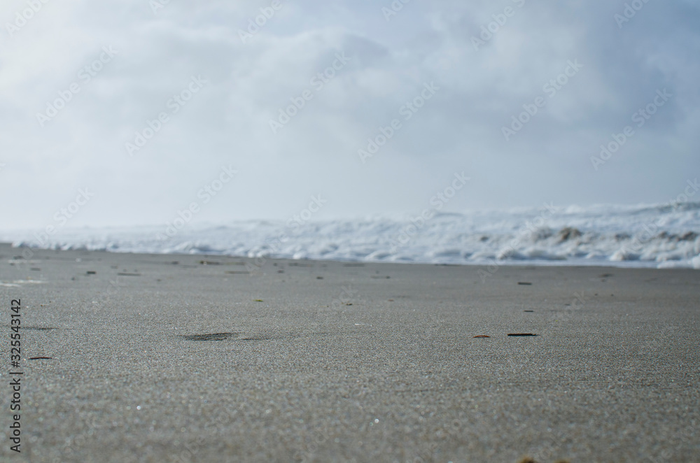 Down on the sand of the cold white beach on the oregon coast. 