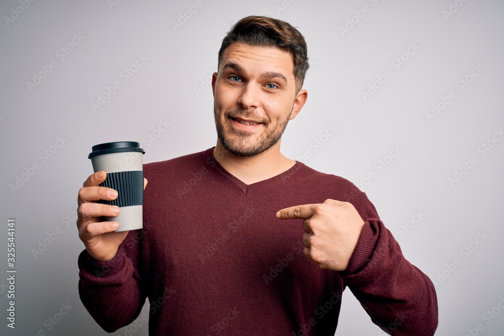 Young man with blue eyes drinking coffee from take away plastic bottle over isolated background with surprise face pointing finger to himself Young man with blue eyes drinking coffee from take away plastic bottle over isolated background with surprise face pointing finger to himself