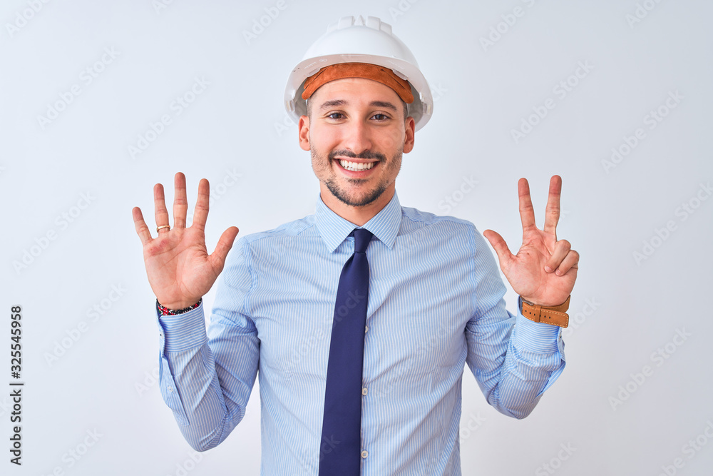 Young business man wearing contractor safety helmet over isolated background showing and pointing up with fingers number eight while smiling confident and happy. Young business man wearing contractor safety helmet over isolated background showing and pointing up with fingers number eight while smiling confident and happy.