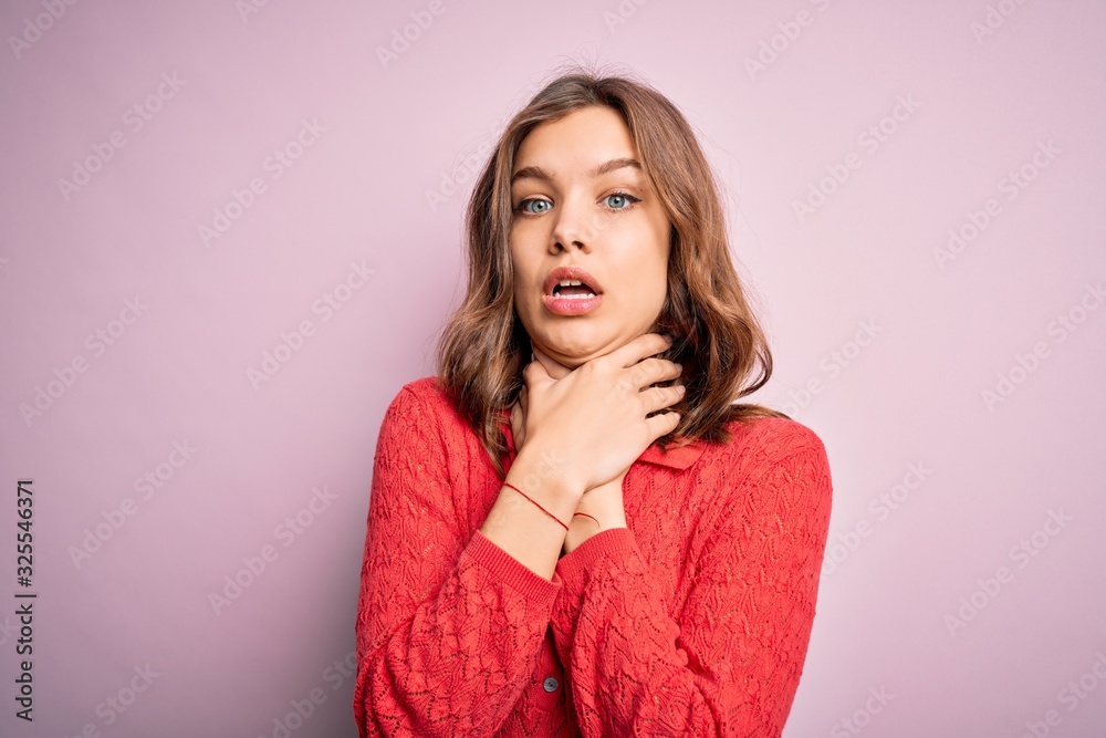 Young beautiful blonde casual girl over pink isolated background shouting and suffocate because painful strangle. Health problem. Asphyxiate and suicide concept. Young beautiful blonde casual girl over pink isolated background shouting and suffocate because painful strangle. Health problem. Asphyxiate and suicide concept.