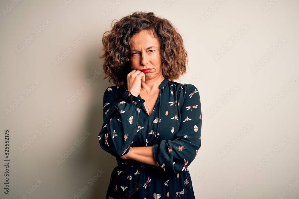 Fototapeta premium Middle age beautiful woman wearing casual dress standing over isolated white background thinking looking tired and bored with depression problems with crossed arms.