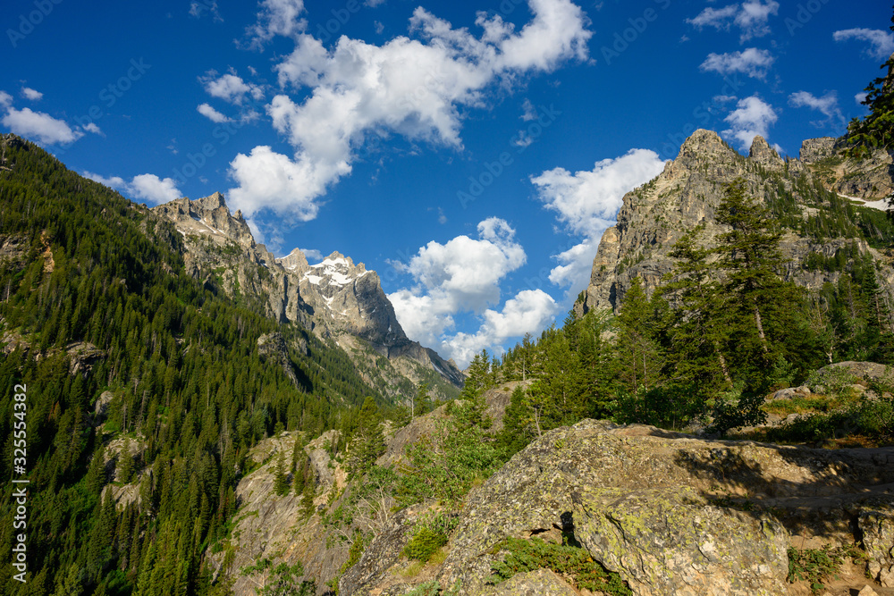 Fototapeta premium Clouds and Blue Sky Over Jagged Peaks of Tetons