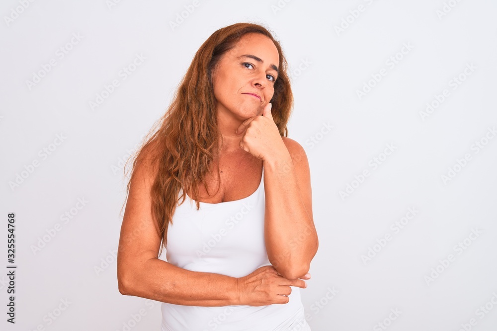 Middle age mature woman standing over white isolated background looking confident at the camera smiling with crossed arms and hand raised on chin. Thinking positive. Middle age mature woman standing over white isolated background looking confident at the camera smiling with crossed arms and hand raised on chin. Thinking positive.