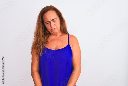 Middle age mature woman standing over white isolated background depressed and worry for distress, crying angry and afraid. Sad expression.