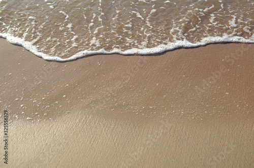 Fototapeta Naklejka Na Ścianę i Meble -  Ocean wave on sandy beach, background