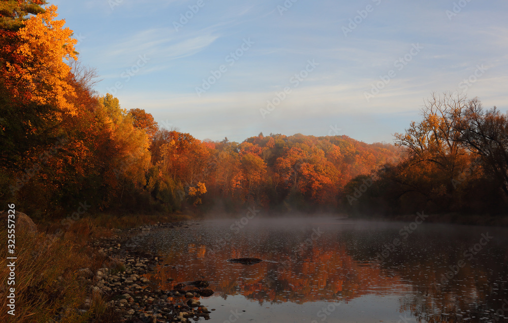 The mist reflecting in the Grand River, shot at daybreak during Autumn, in Kitchener, Ontario, Canada.