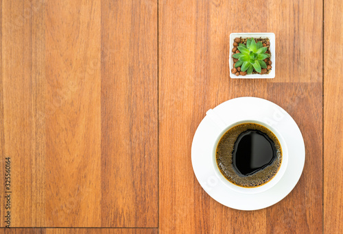 White cup of coffee on wood background