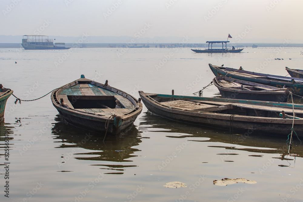 Old boats on river Ganga in Varanasi, Uttar Pradesh, India. Mornig time, sunrise.