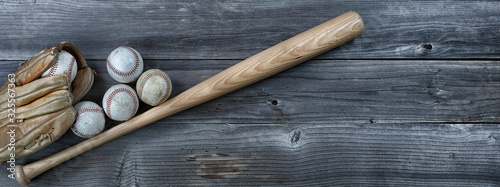 Fotografie Used baseball equipment on vintage wooden background