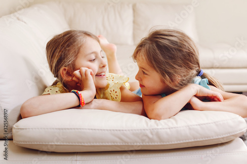 Fotografie Two cute little Caucasian girls siblings playing at home
