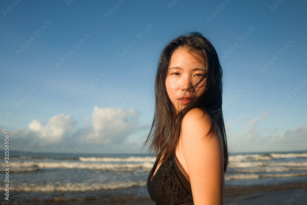 young attractive and cool Asian Japanese woman in swimsuit walking on beautiful beach paradise feeling relaxed enjoying holidays in exotic travel destination young attractive and cool Asian Japanese woman in swimsuit walking on beautiful beach paradise feeling relaxed enjoying holidays in exotic travel destination