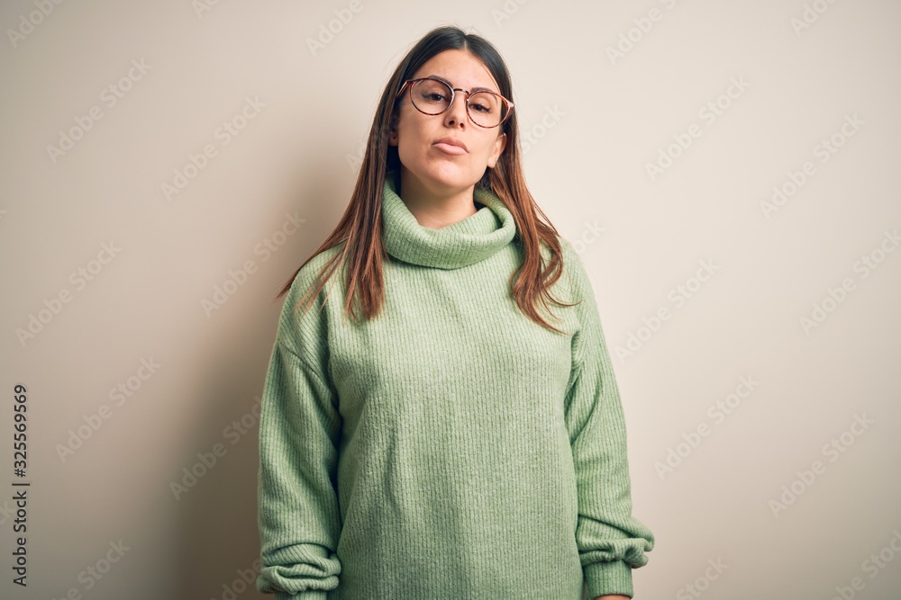 Young beautiful woman wearing casual sweater standing over isolated white background Relaxed with serious expression on face. Simple and natural looking at the camera. Young beautiful woman wearing casual sweater standing over isolated white background Relaxed with serious expression on face. Simple and natural looking at the camera.