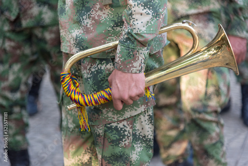 Принти на полотні Man holding military cornet of the Colombian army.