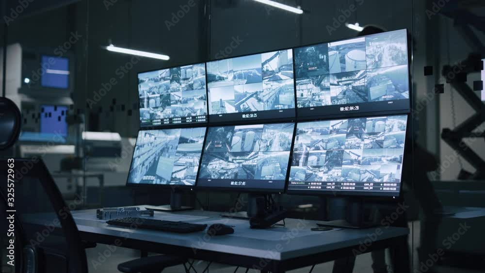 Industry 4.0 Modern Factory: Security Control Room with Multipoke Computer Screens Showing Surveillance Camera Footage Feed. High-Tech Security Industry 4.0 Modern Factory: Security Control Room with Multipoke Computer Screens Showing Surveillance Camera Footage Feed. High-Tech Security