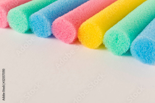 Foam colored curlers on a light background. Abstract background. Selective focus. photo