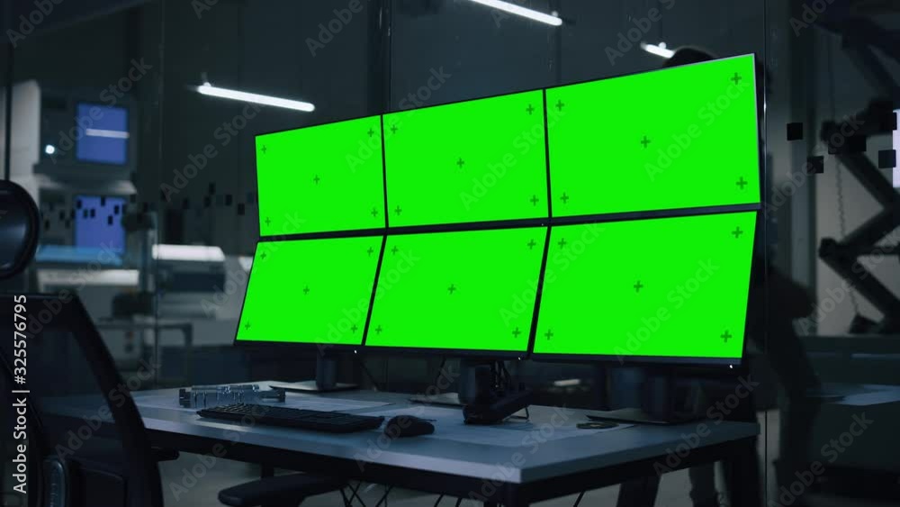 Industry 4.0 Modern Factory: Computer with Multiple Chroma Key / Green Screen Displays. In Background High-Tech Fully Automatic Electronics Producing Industrial Facility Industry 4.0 Modern Factory: Computer with Multiple Chroma Key / Green Screen Displays. In Background High-Tech Fully Automatic Electronics Producing Industrial Facility