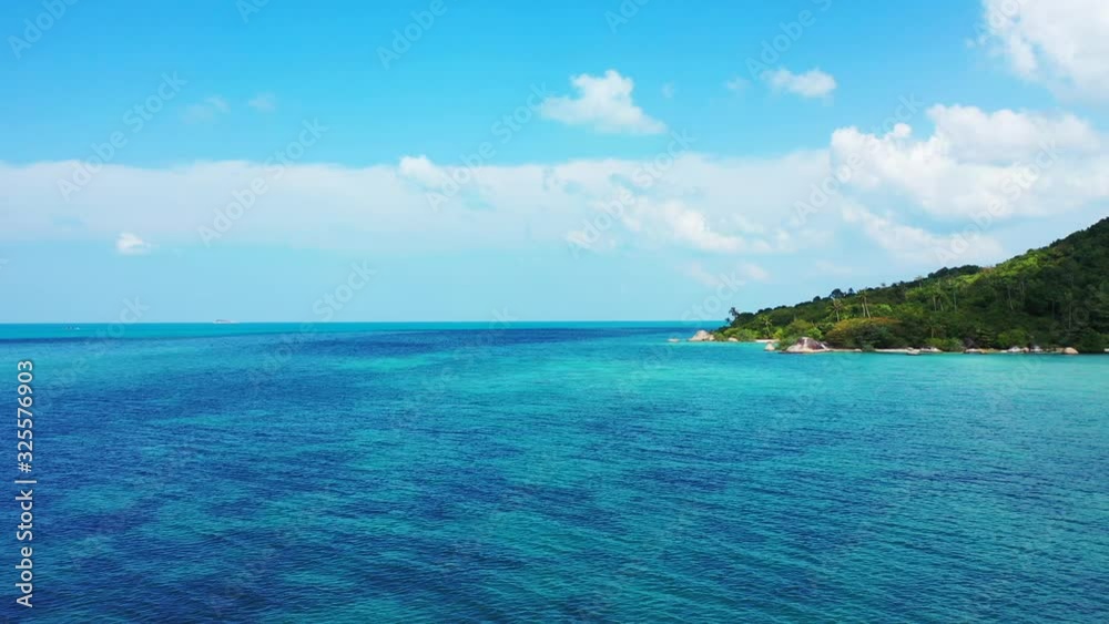 Thailand tropical island and turquoise sea background. Bright blue sky and fluffy clouds above the uninhabited cay Thailand tropical island and turquoise sea background. Bright blue sky and fluffy clouds above the uninhabited cay
