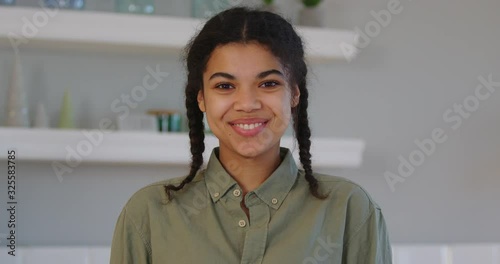 Smiling african woman in khaky shirt laughing and looking at the camera photo