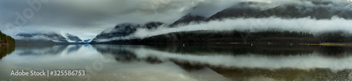 Panorama of lake, mountain, clouds on a cold winter morning