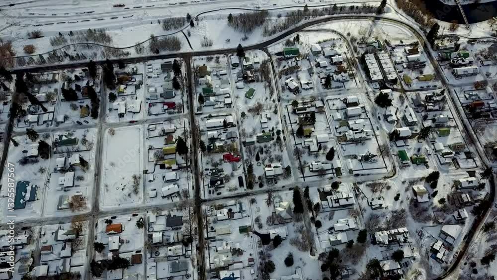 Aerial view flying over a snowy small town in the winter Aerial view flying over a snowy small town in the winter