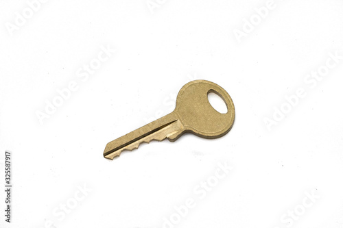 A brass padlock key, close up, isolated on a clean, white background.  Shot in macro. © Peter