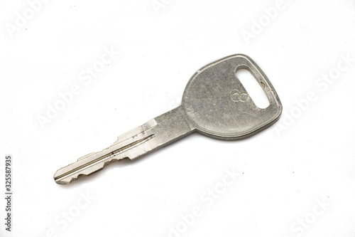 A silver auto key, close up, isolated on a clean, white background.  Shot in macro. © Peter
