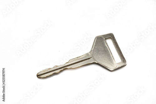A silver car key, close up, isolated on a clean, white background.  Shot in macro. © Peter