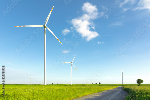 Wallpaper Mural wind turbines on blue sky in green field Torontodigital.ca