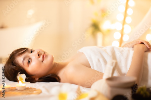 Asian Beautiful, young and healthy woman in spa salon. Massage treatment spa room . Traditional medicine and healing concept.