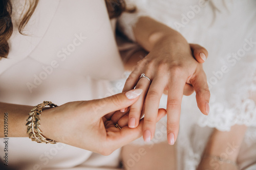 girls in white dresses with jewelry on hands holding hands