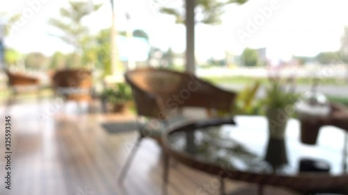 blur scene outdoor cafe with table seat outside garden view in the morning