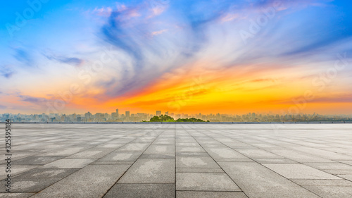 Wide square floor and city skyline at sunrise in Hangzhou China.