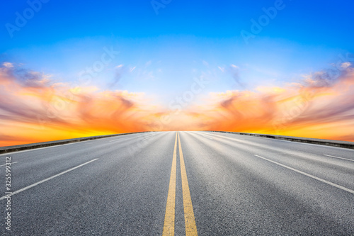 Empty asphalt road and beautiful colorful clouds landscape at sunset.