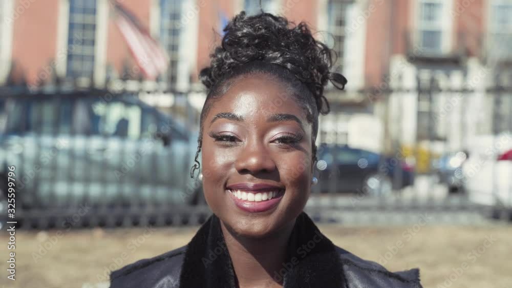 Portrait of Beautiful Stylish African American Woman With Makeup Smiling At Camera With Confidence On A Sunny Day In The City, Wearing Black Clothes, Close Up Shot