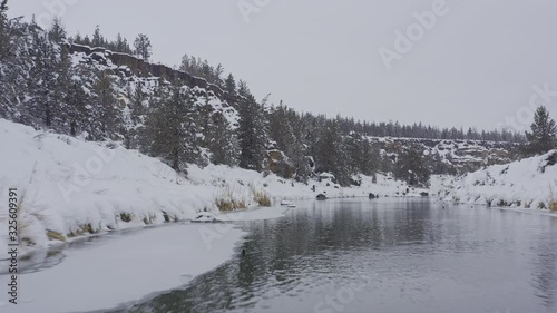 Oregon Aerial v41 Following path of snowy river landscape with flock of ducks and park views - March 2019 photo