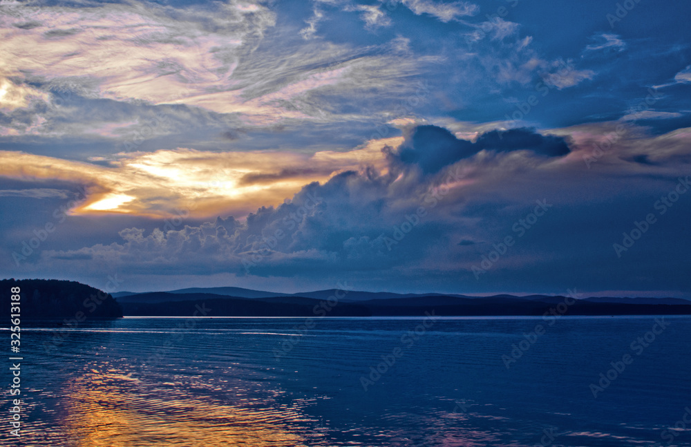 Fototapeta premium forest lake at sunset with beautiful clouds