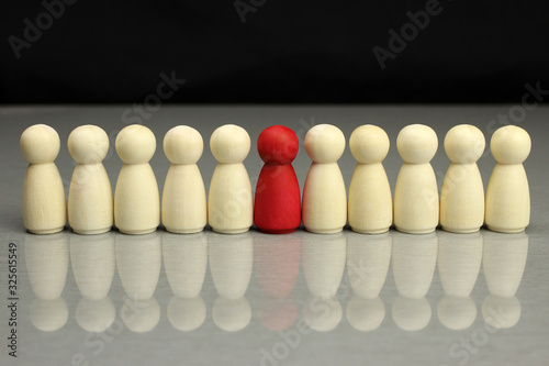 Red wooden figurine Stand out from the crowd in the line  the symbol of leadership