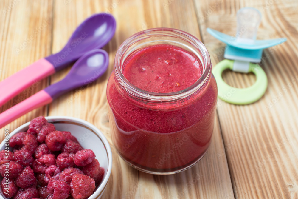 baby raspberry puree in a jar. baby food. baby raspberry puree in a jar. baby food.